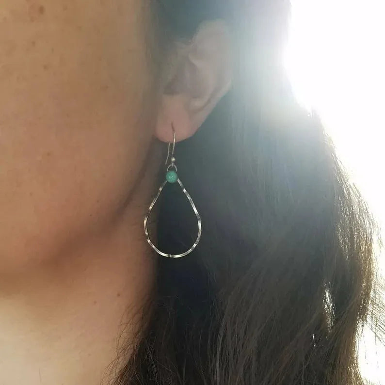 Bohemian style geometric circle earrings with antique silver finish and turquoise accent