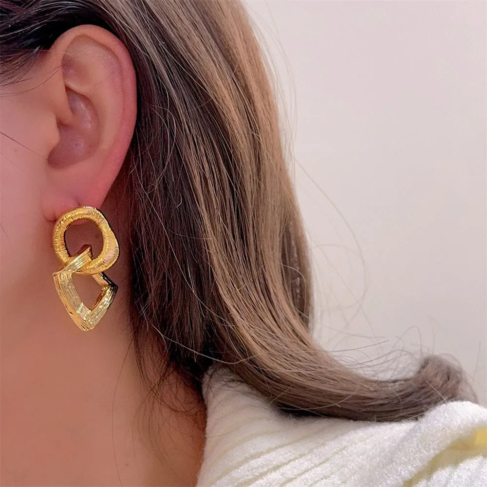 Geometric circle pendant earrings with gold electroplated finish showing 3.4 cm height measurement