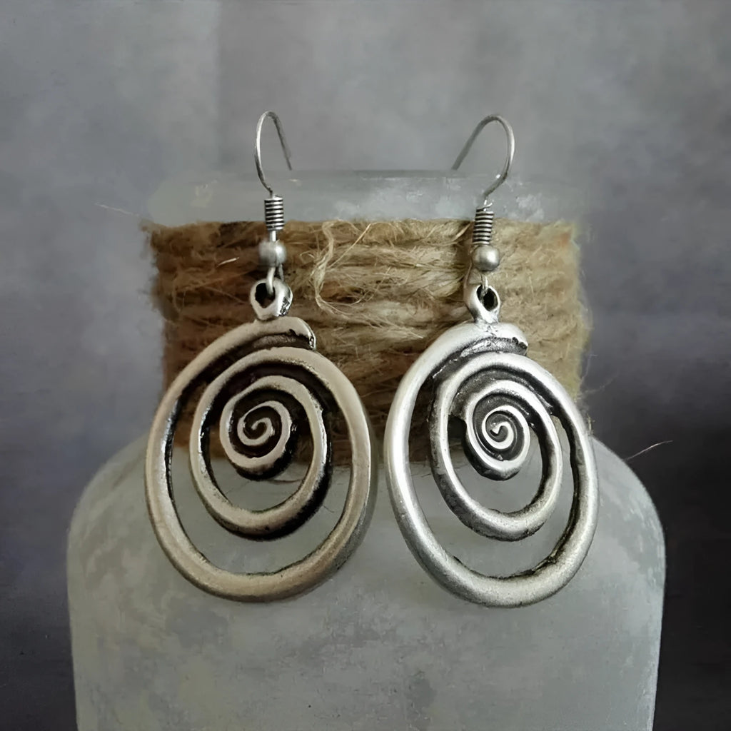 Silver geometric spiral earrings with distressed finish, measuring 2.6cm wide by 5cm long