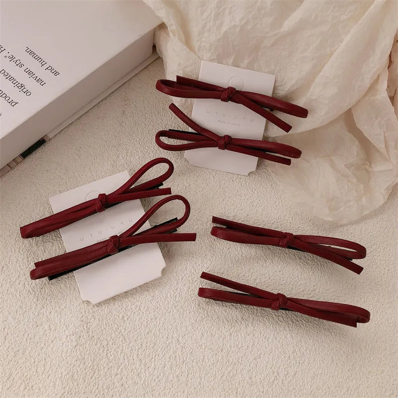 Wine red leather bow barrettes hair clips showing bow design and leather material