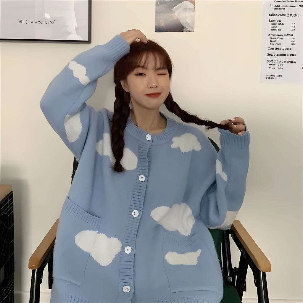 Blue women's cardigan with white cloud pattern, loose fit and long sleeves.