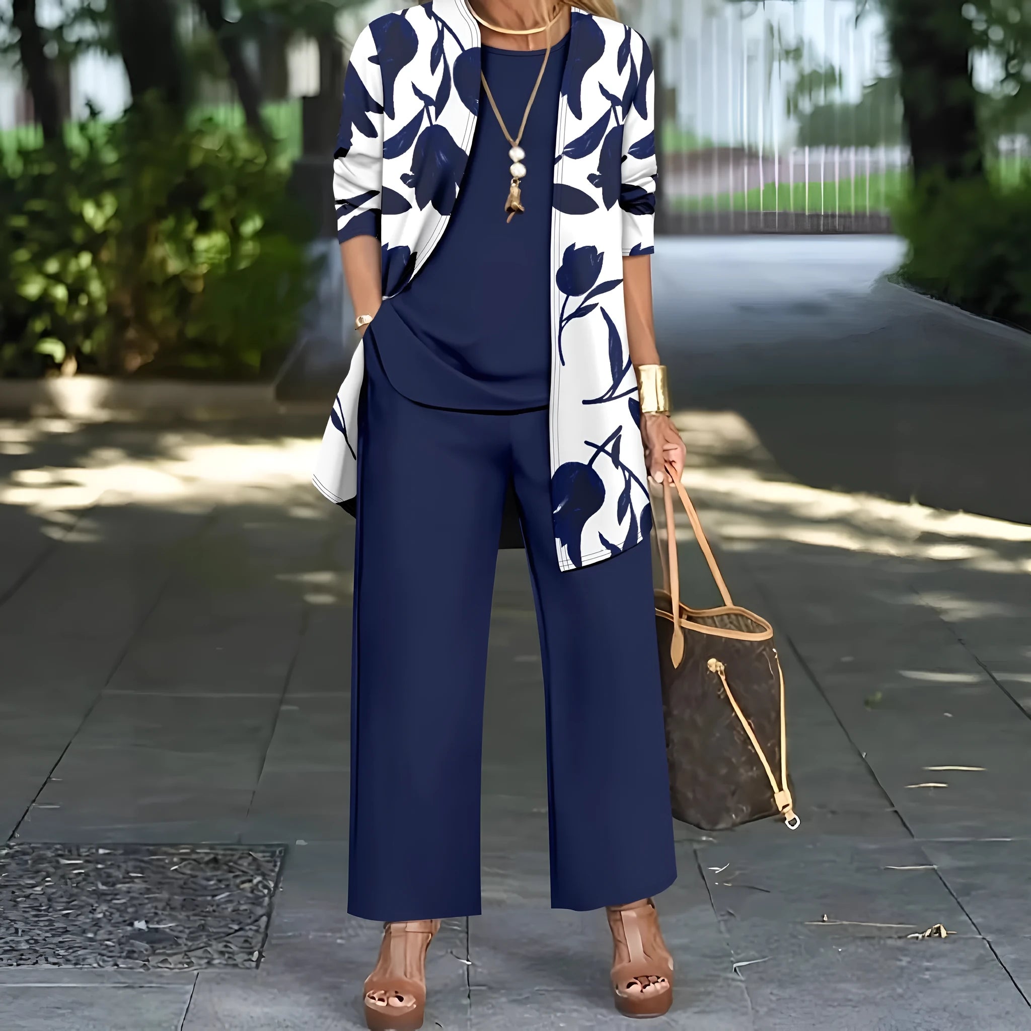 Women's blue three-piece casual suit comprising a long-sleeve coat, a vest, and trousers on a hanger.