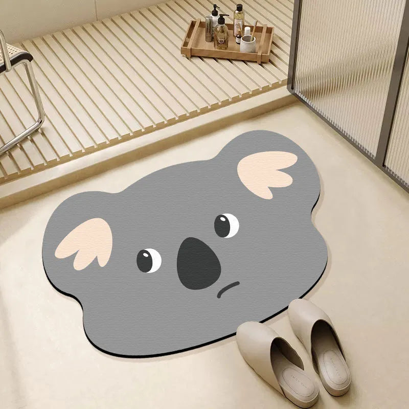Cartoon animal diatomite bathroom mat in alien shape on tiled floor.