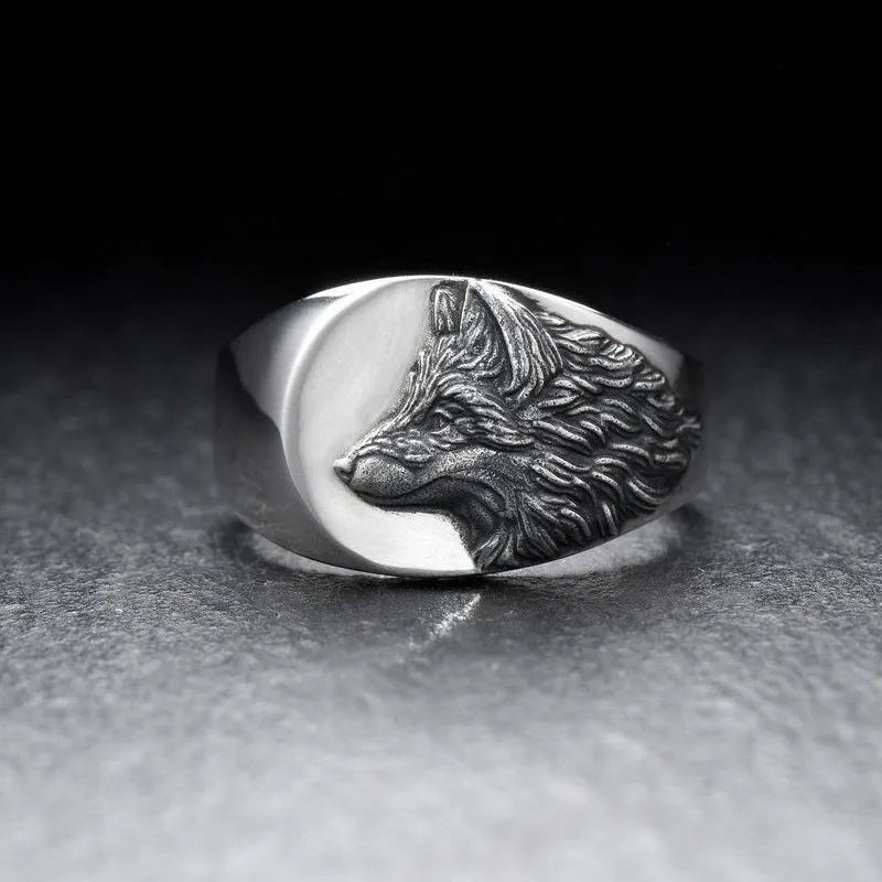 Men's silver geometric wolf head alloy ring on a grey background.