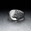 Men's silver geometric wolf head alloy ring on a grey background.