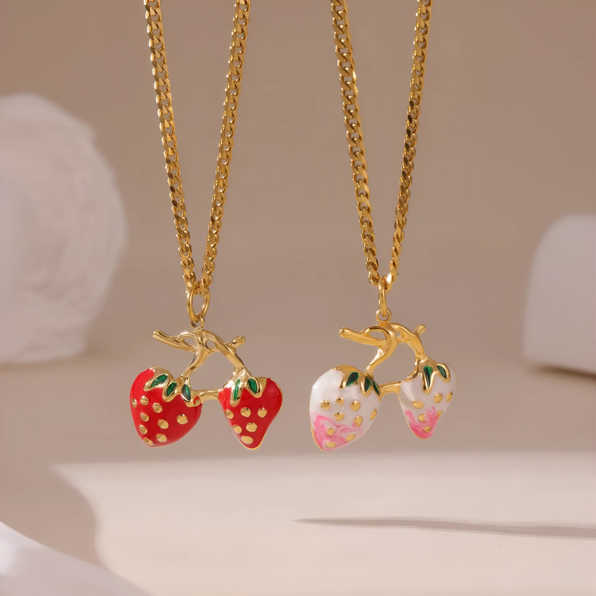 Stainless steel strawberry fruit pendant necklace on an alloy chain, shown in red and white gradient colour options.