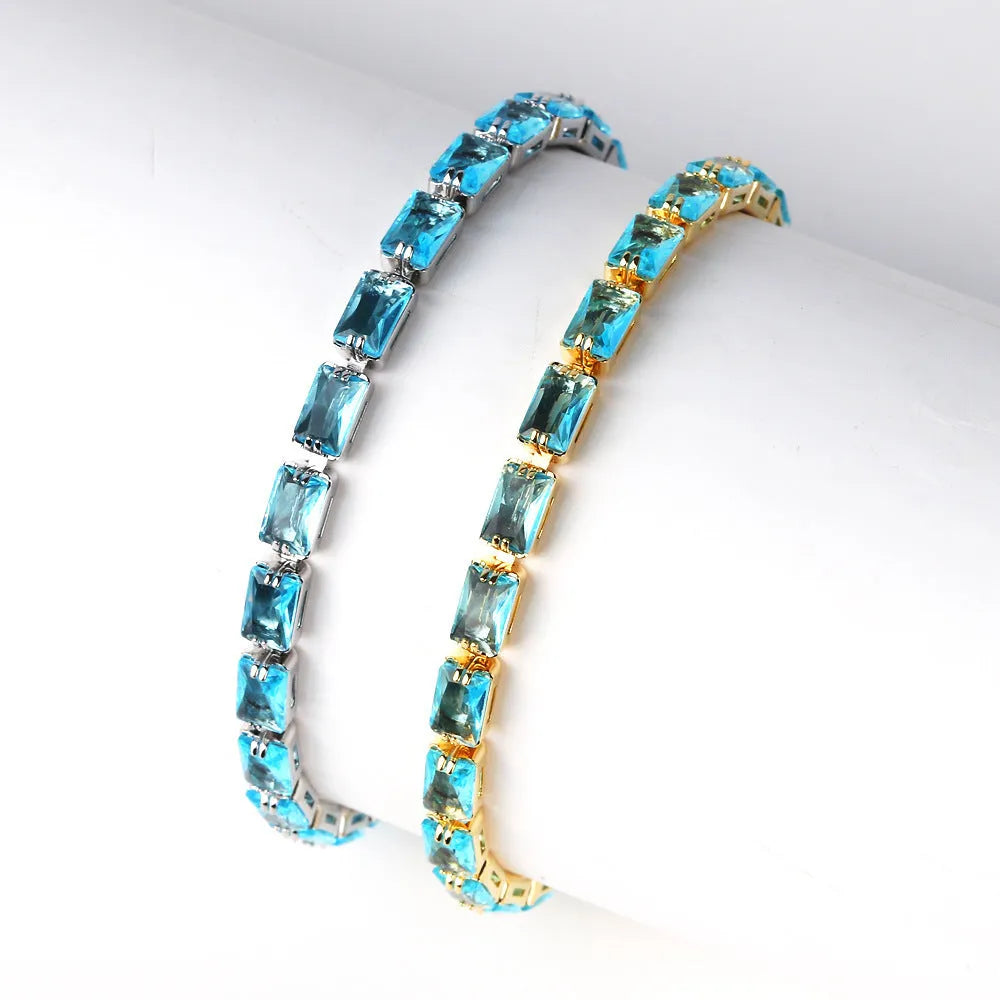 Adjustable electroplated zircon bracelet in gold finish with coloured zircon accents