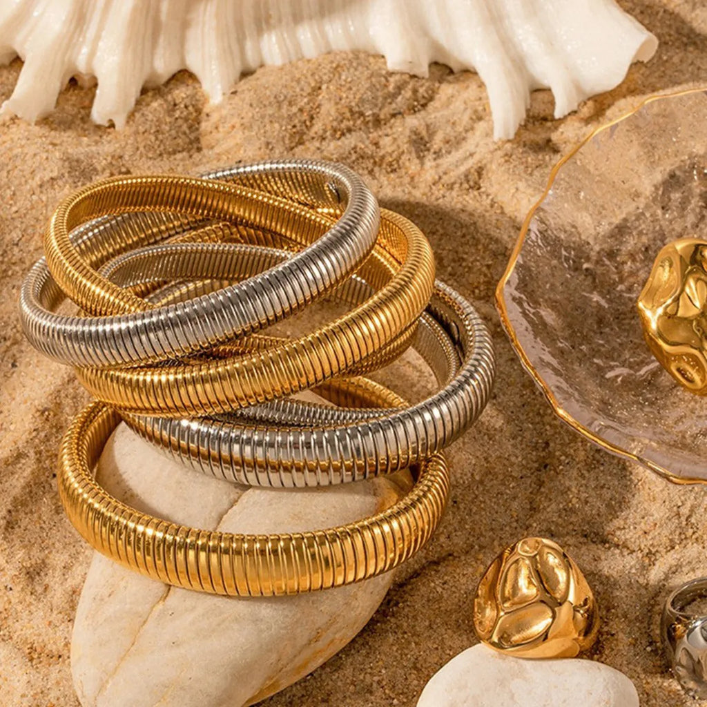 Women's titanium steel bracelet with vertical stripe pattern in gold or silver finish