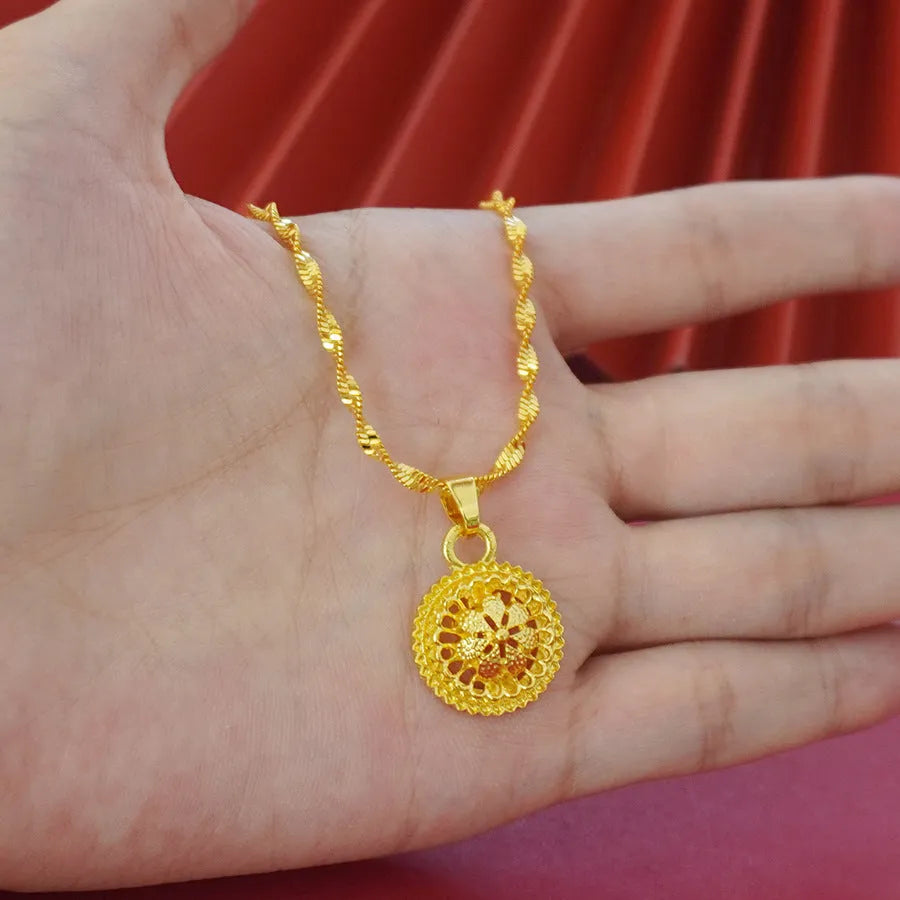 Women's three-piece jewellery set showing gold electroplated necklace with floral pendant, matching earrings, and ring with Middle Eastern design