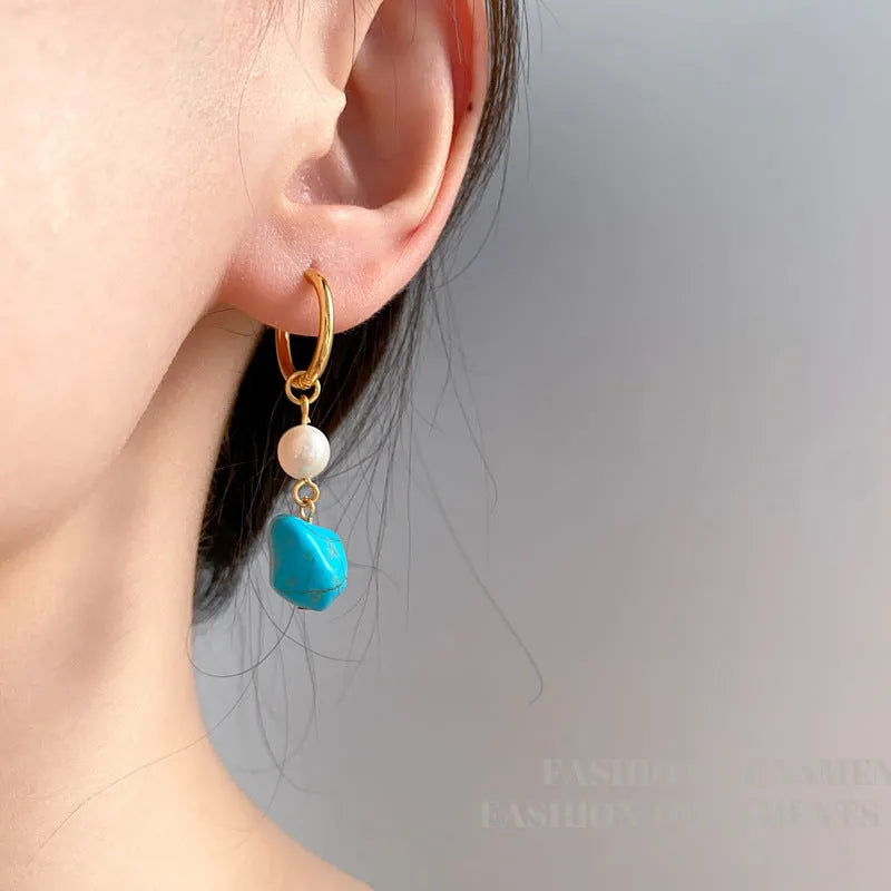 A pair of short and a pair of dangle geometric turquoise copper earrings.