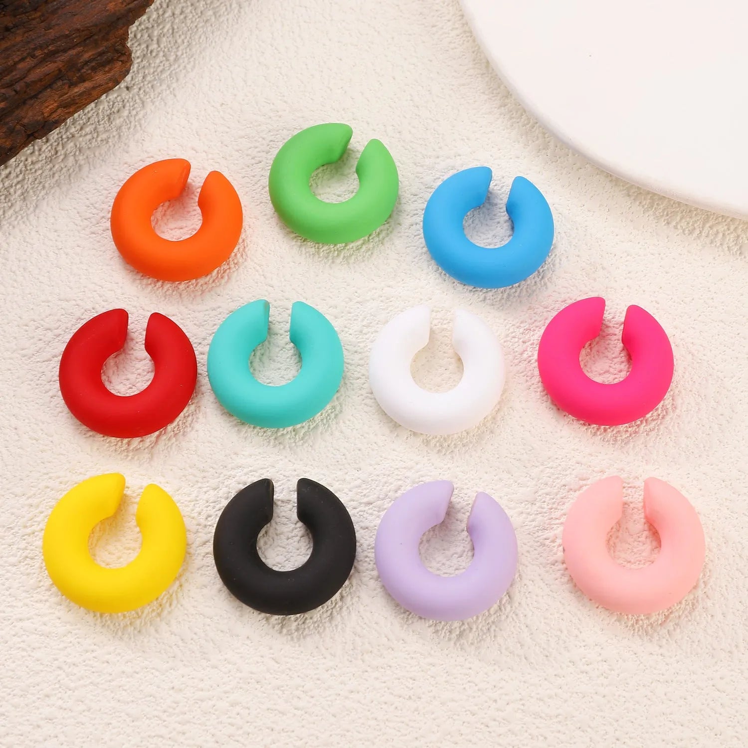 Geometric C-shape clip-on earrings with matte coarse finish in candy colours for women without pierced ears