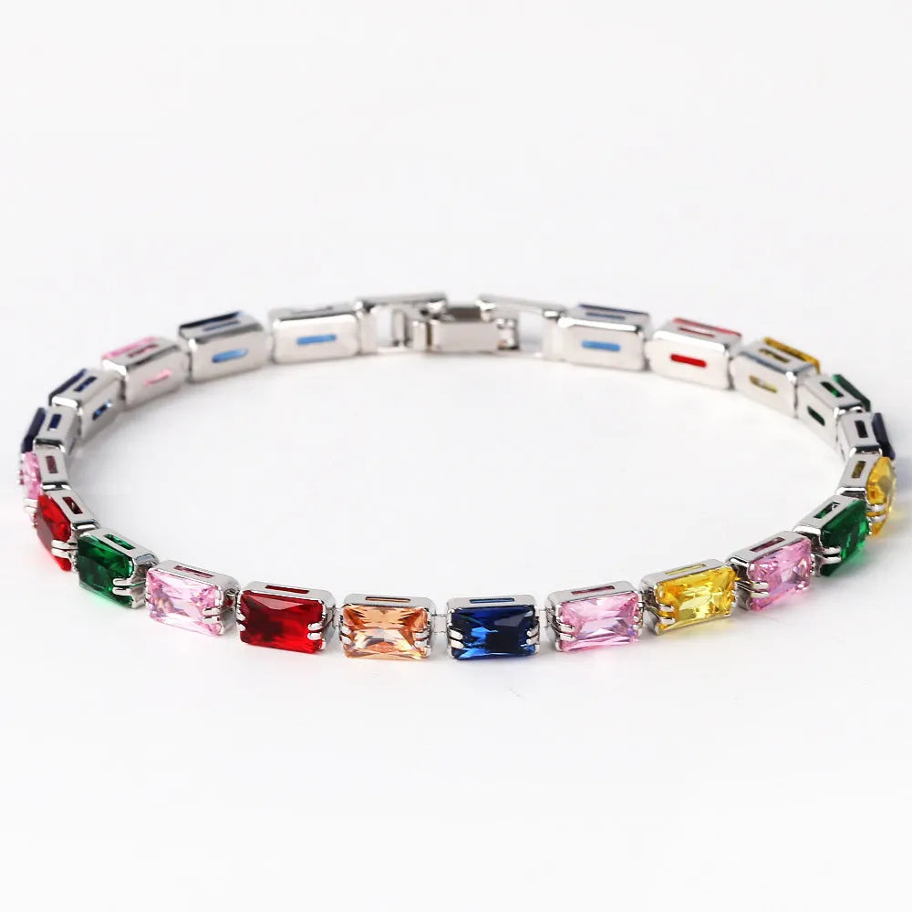 Adjustable electroplated zircon bracelet in gold finish with coloured zircon accents