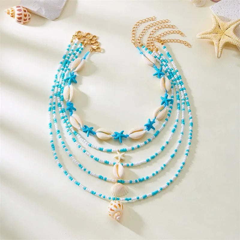 Five multi-layer beaded necklaces with starfish and shell charms in blue and colours