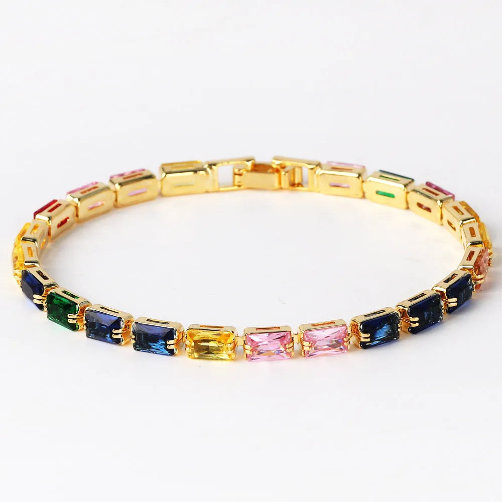 Adjustable electroplated zircon bracelet in gold finish with coloured zircon accents