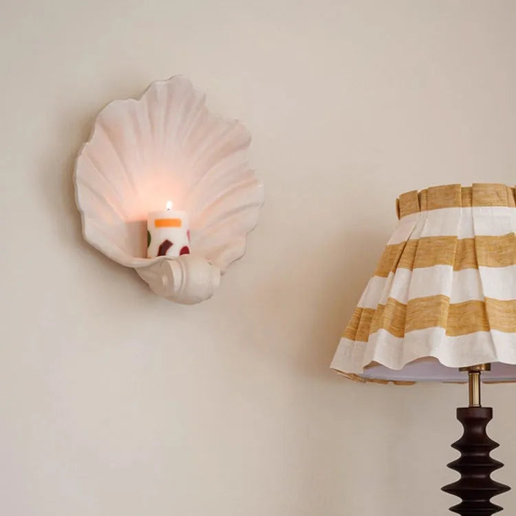 White resin simulation shell fruit plate ornament on a table.