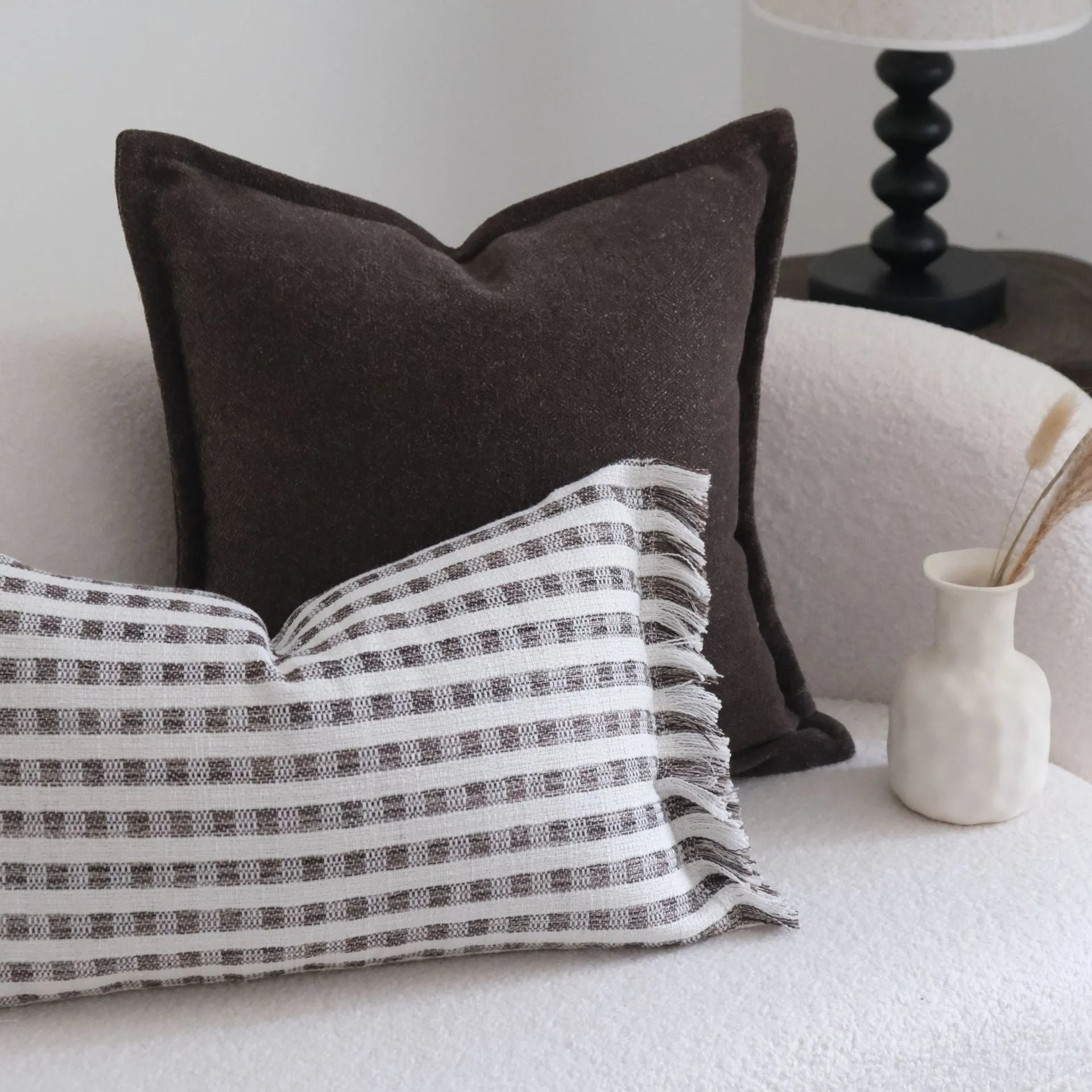 Coffee brown striped Chinese classical style cushion pillow on a sofa in 45x45cm size.