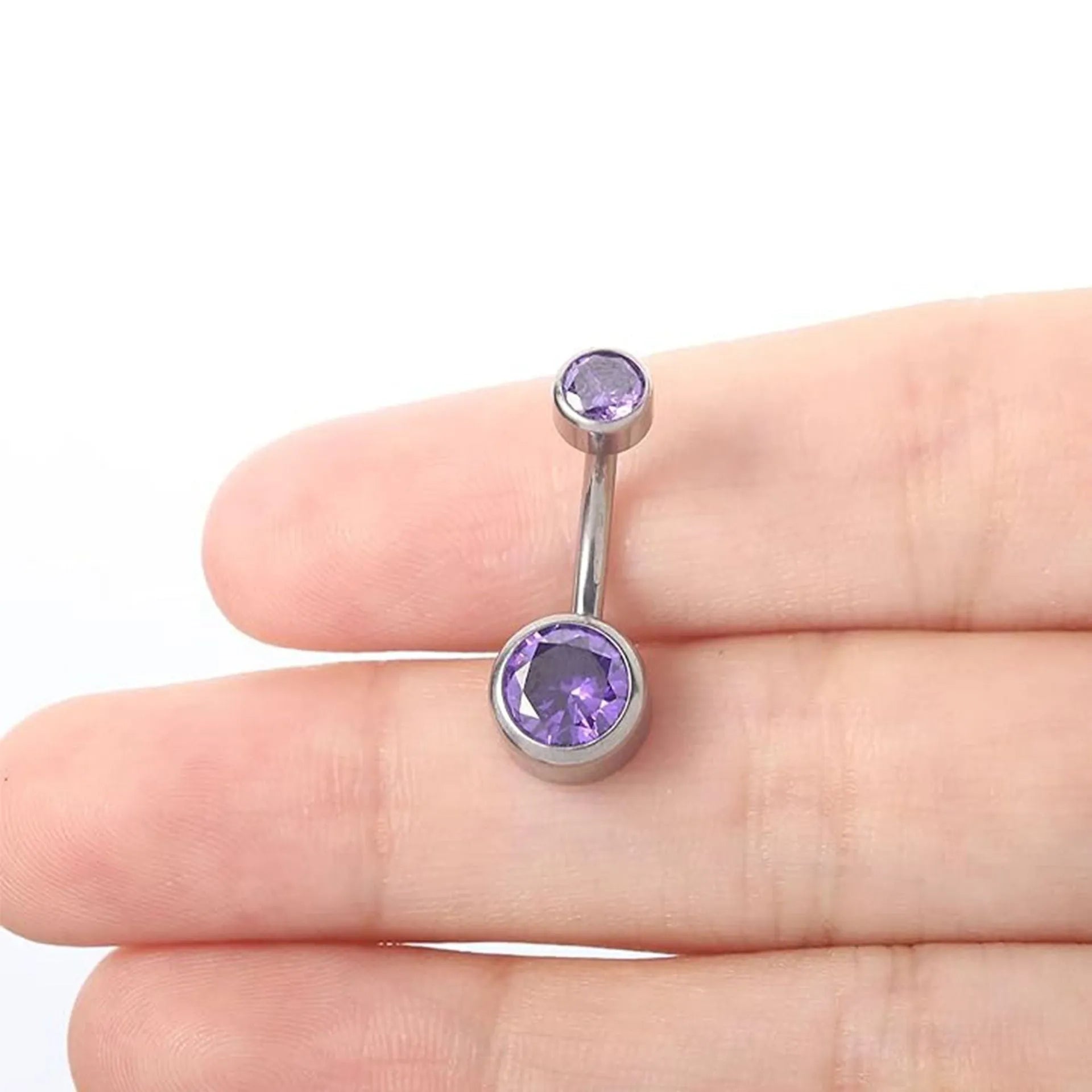 Double-headed zircon titanium alloy navel stud in various colours on a white background.
