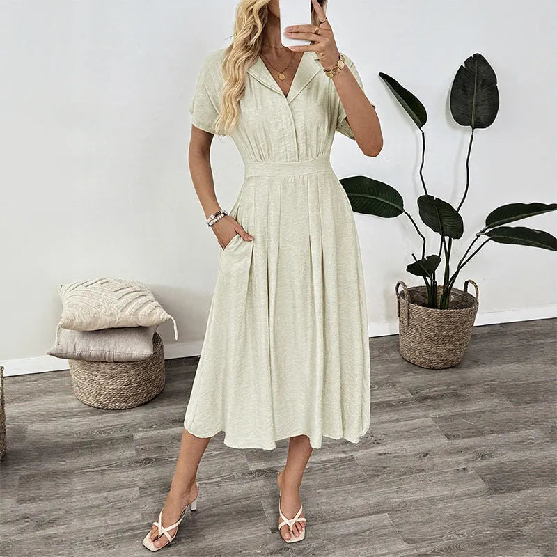 Light green twill shirtdress with lapel collar, waist-tight skirt, and commuter pocket design