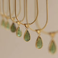 Retro blue and green water drop necklace with gemstone inlay on a titanium steel snake bone chain.