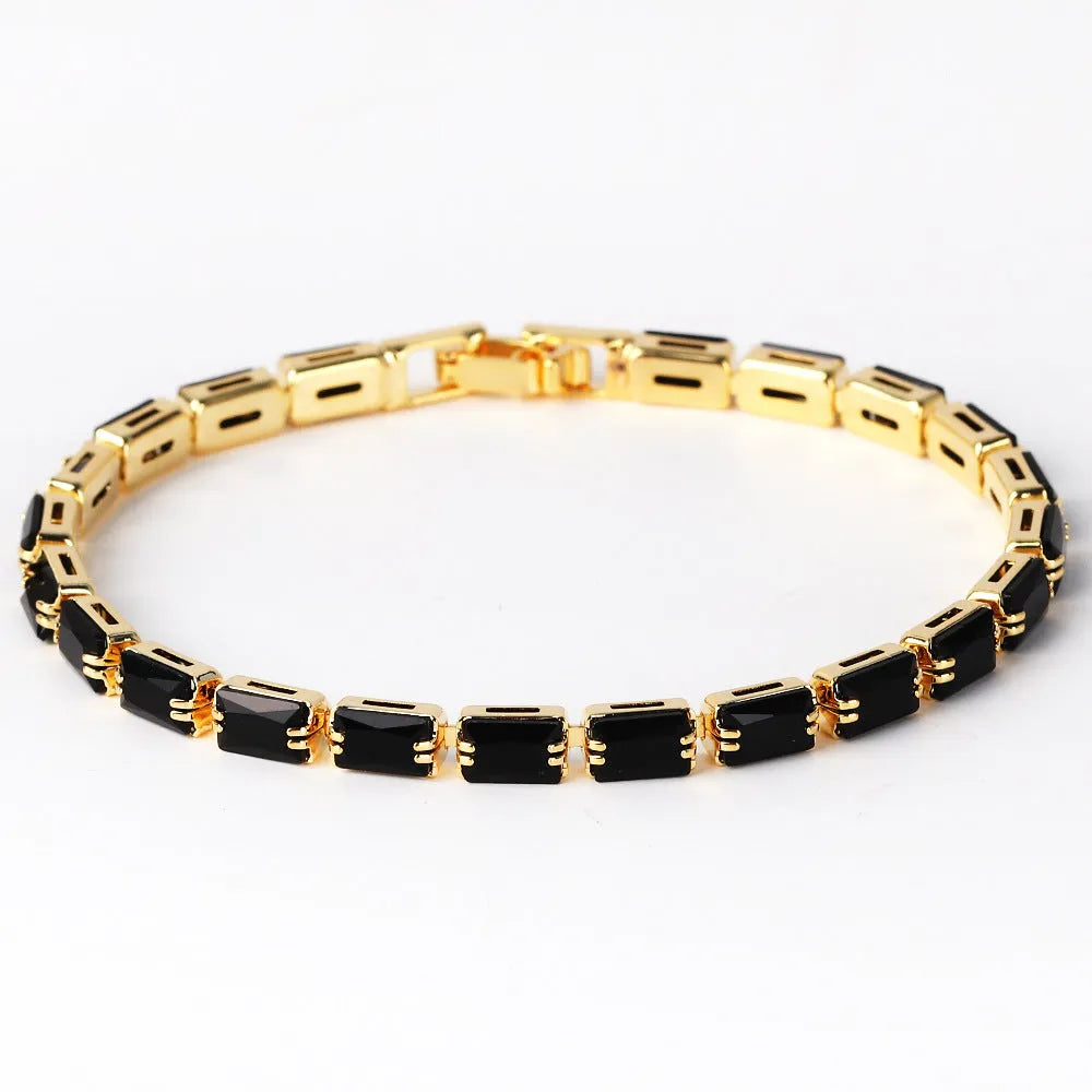 Adjustable electroplated zircon bracelet in gold finish with coloured zircon accents