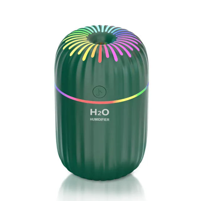 Mini animal-shaped USB aromatherapy humidifier in green, pink, or white colour on a desk.