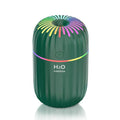 Mini animal-shaped USB aromatherapy humidifier in green, pink, or white colour on a desk.