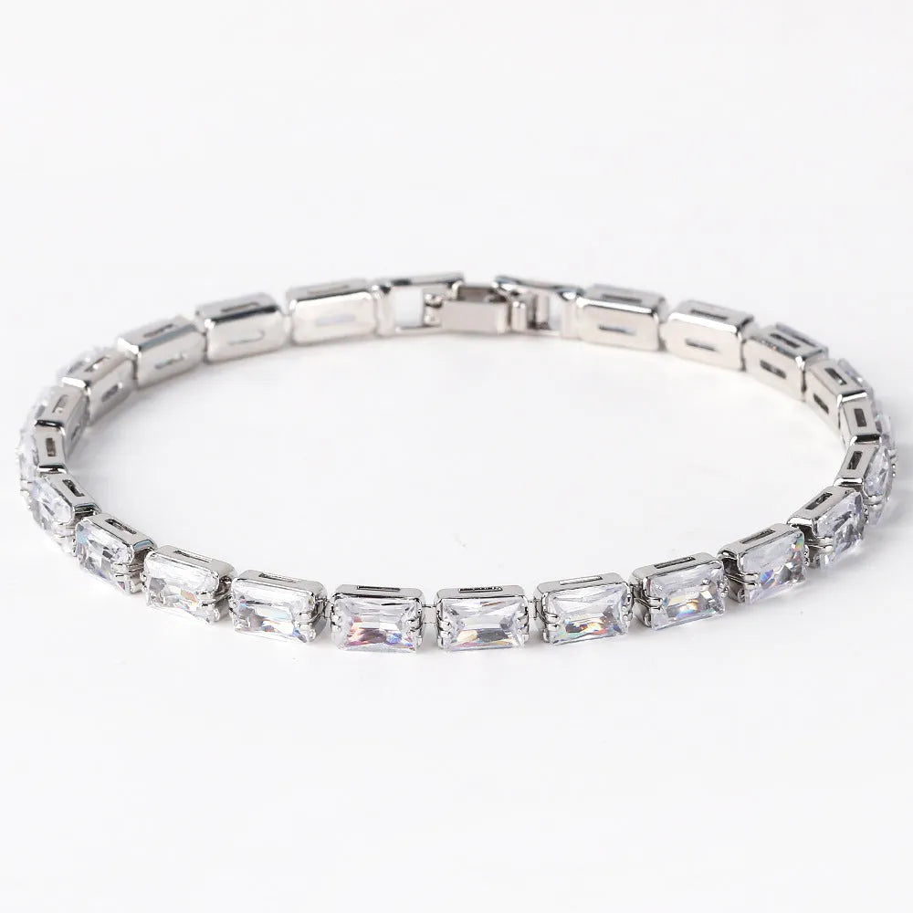 Adjustable electroplated zircon bracelet in gold finish with coloured zircon accents