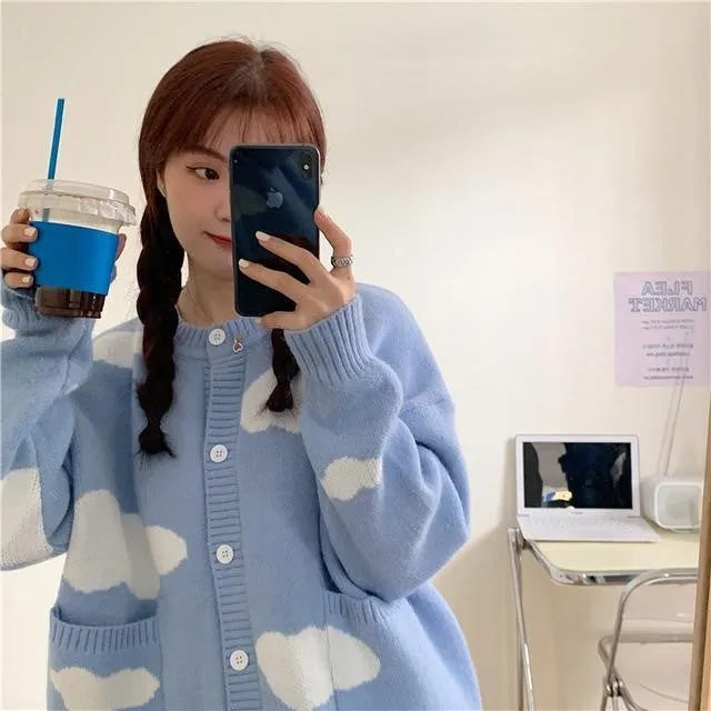 Blue women's cardigan with white cloud pattern, loose fit and long sleeves.