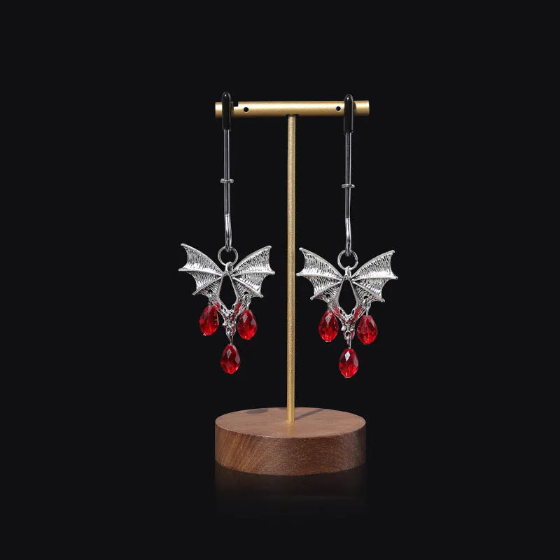 Silver alloy bat nipple clamp with ruby design showing adjustable pressure mechanism