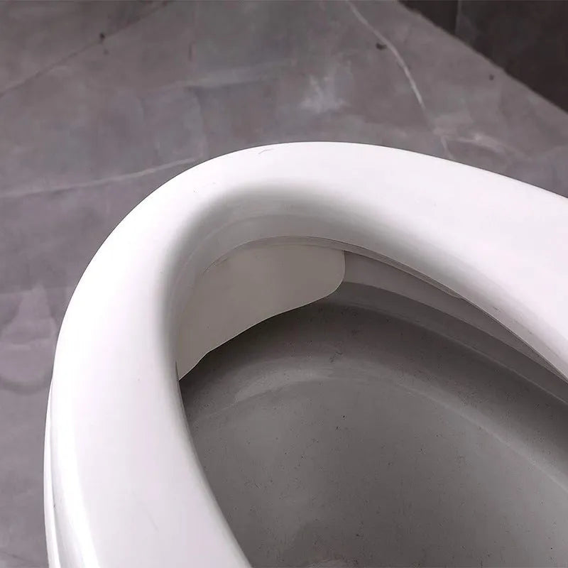 White PVC toilet training splash guard for children placed on toilet seat