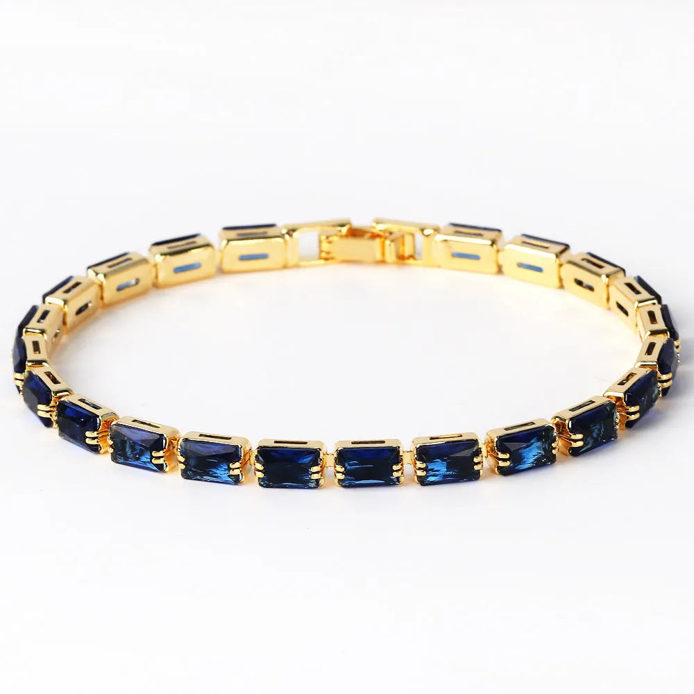 Adjustable electroplated zircon bracelet in gold finish with coloured zircon accents