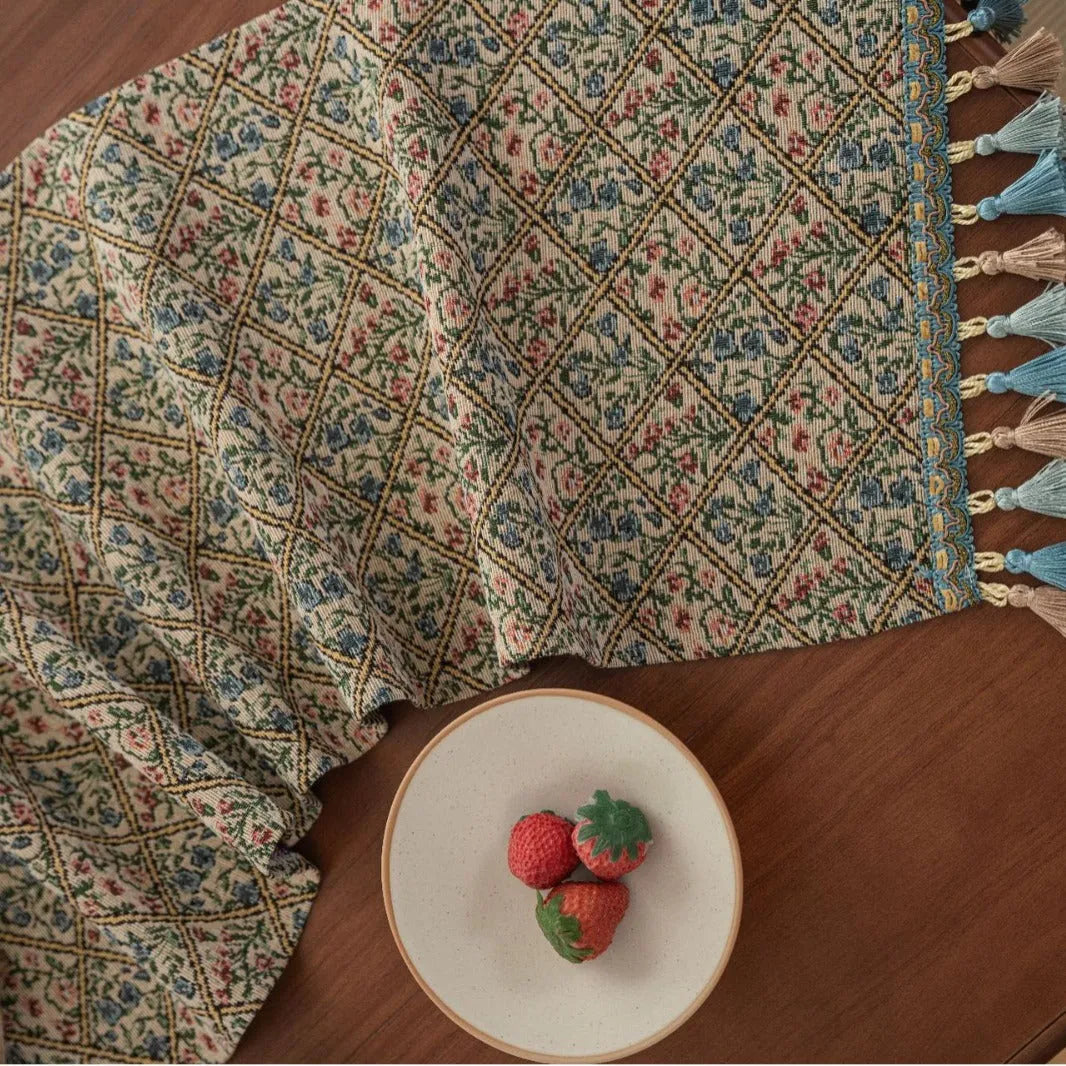 Nordic jacquard bouquet pattern table runner with decorative tassel trim in dark blue colour