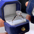 White gold plated women's ring with a geometric design and a six-claw set zircon stone.