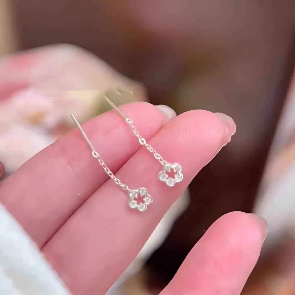 Pair of silver hollow flower stud earrings with detailed petals, alloy material with natural style