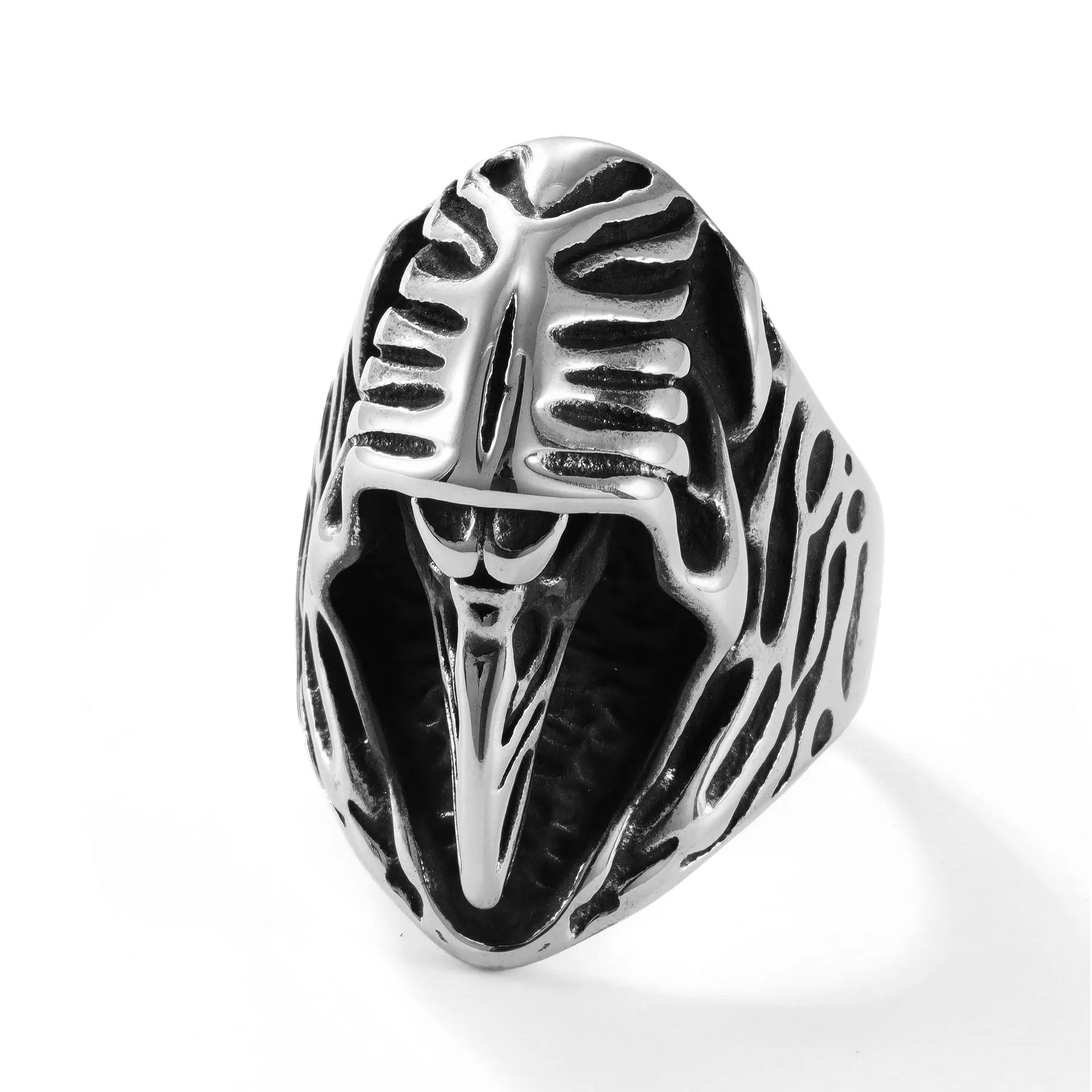 Geometric titanium steel crow ring in a punk retro style on a grey background.