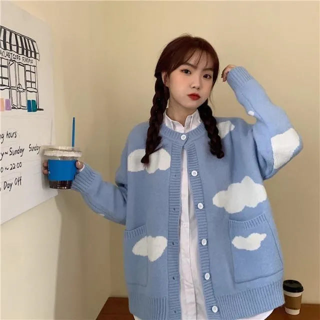 Blue women's cardigan with white cloud pattern, loose fit and long sleeves.