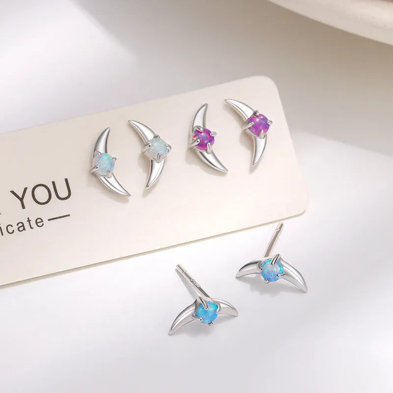 A pair of geometric drop earrings made from 925 silver with a coloured cubic zirconia stone.