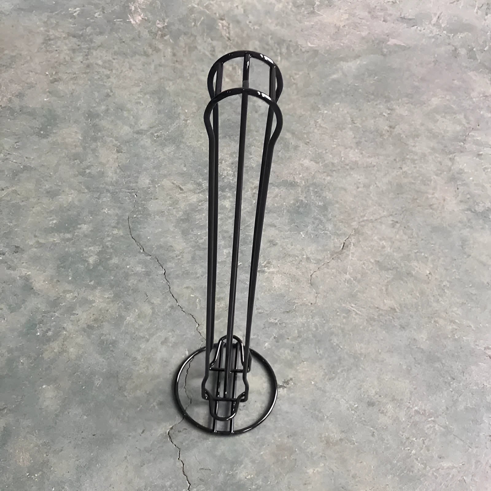 Wrought iron coffee capsule storage rack holding multiple pods with spray black finish