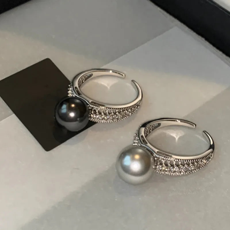 Geometric open copper ring for women with a black pearl on an adjustable band.
