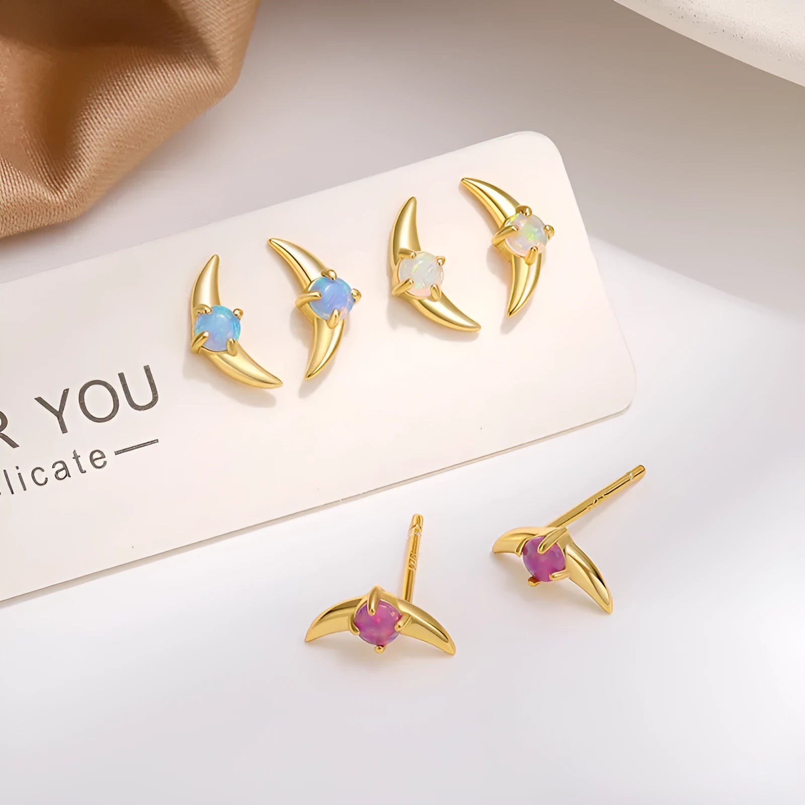 A pair of geometric drop earrings made from 925 silver with a coloured cubic zirconia stone.