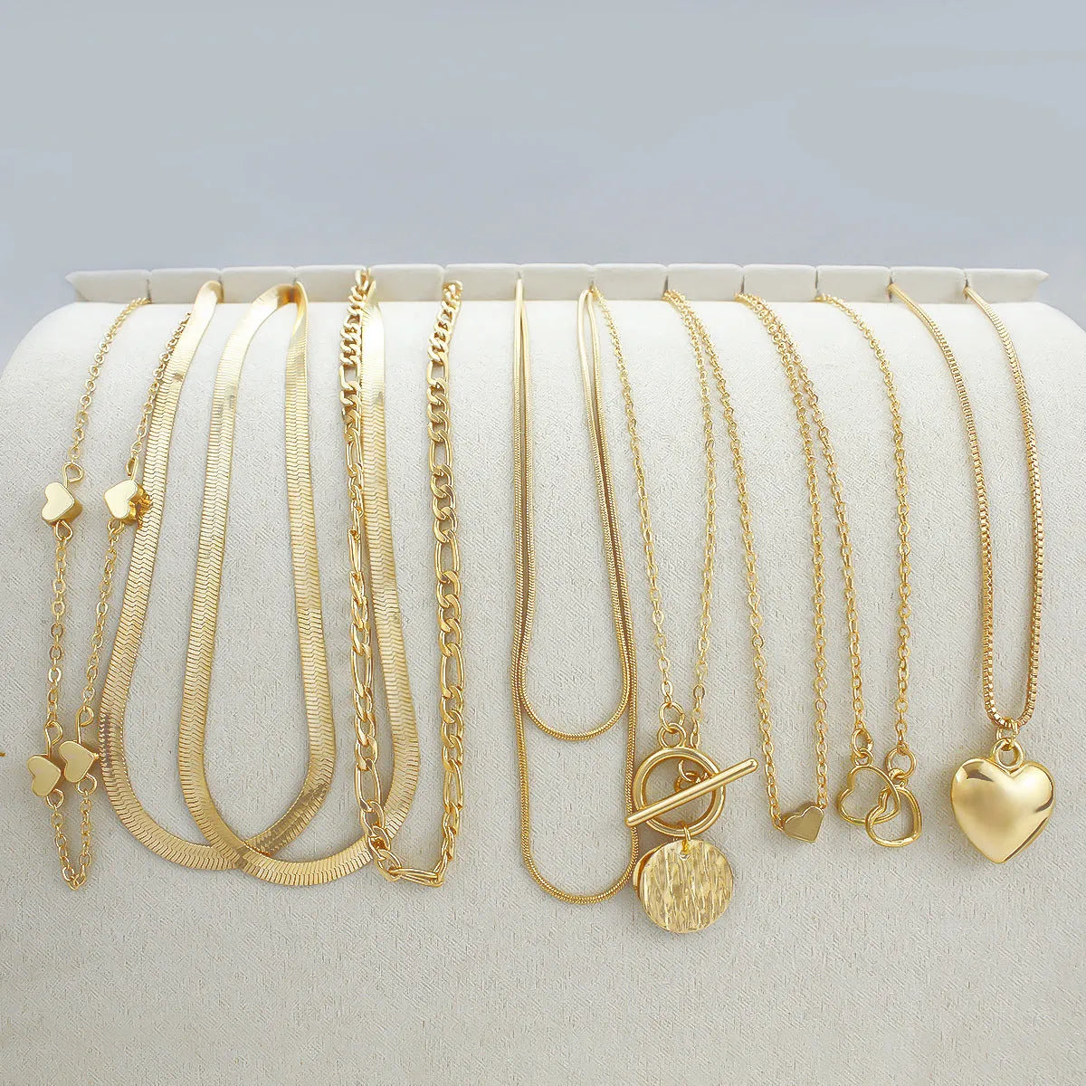 Women's gold electroplated necklace set with ten alloy pendants on adjustable snake bones chain