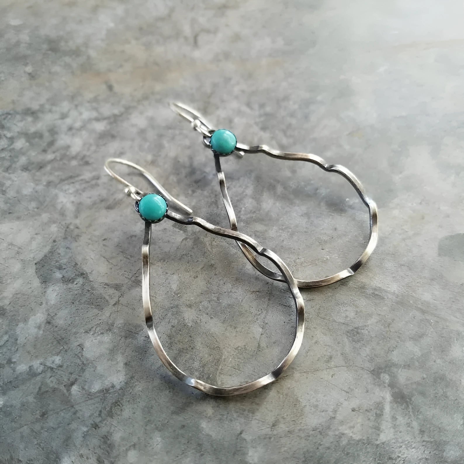 Bohemian style geometric circle earrings with antique silver finish and turquoise accent
