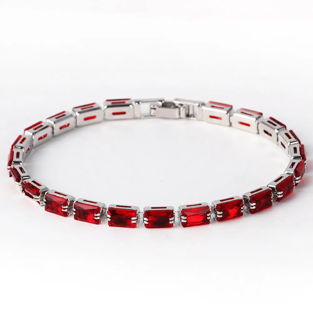 Adjustable electroplated zircon bracelet in gold finish with coloured zircon accents