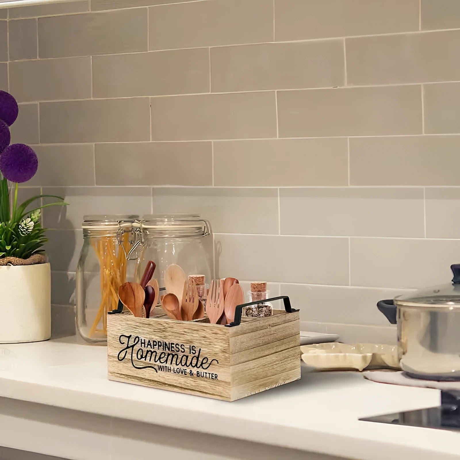 Modern minimalist wooden box with grid dividers for organising kitchen utensils.