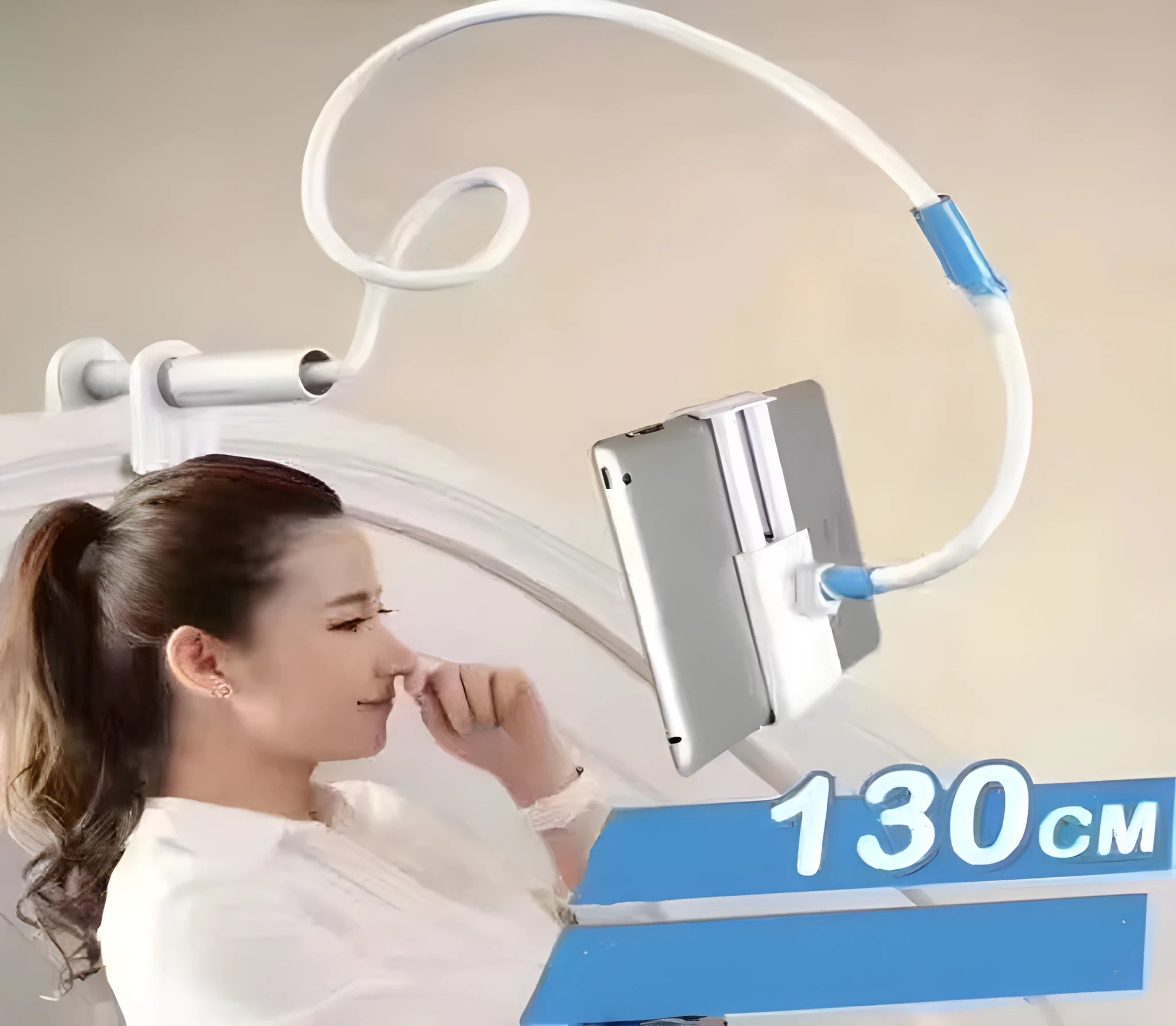 Blue universal mobile phone holder with 120cm pole clamped to bedside table holding a tablet