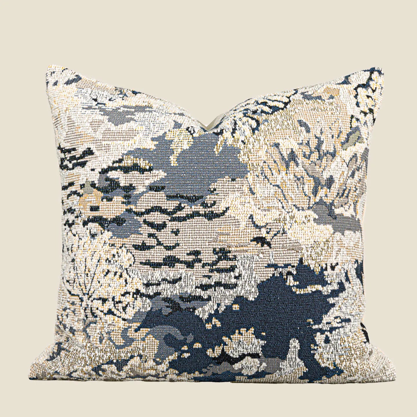 Blue decorative pillow with abstract flower pattern in 50x50cm square size on a grey sofa.