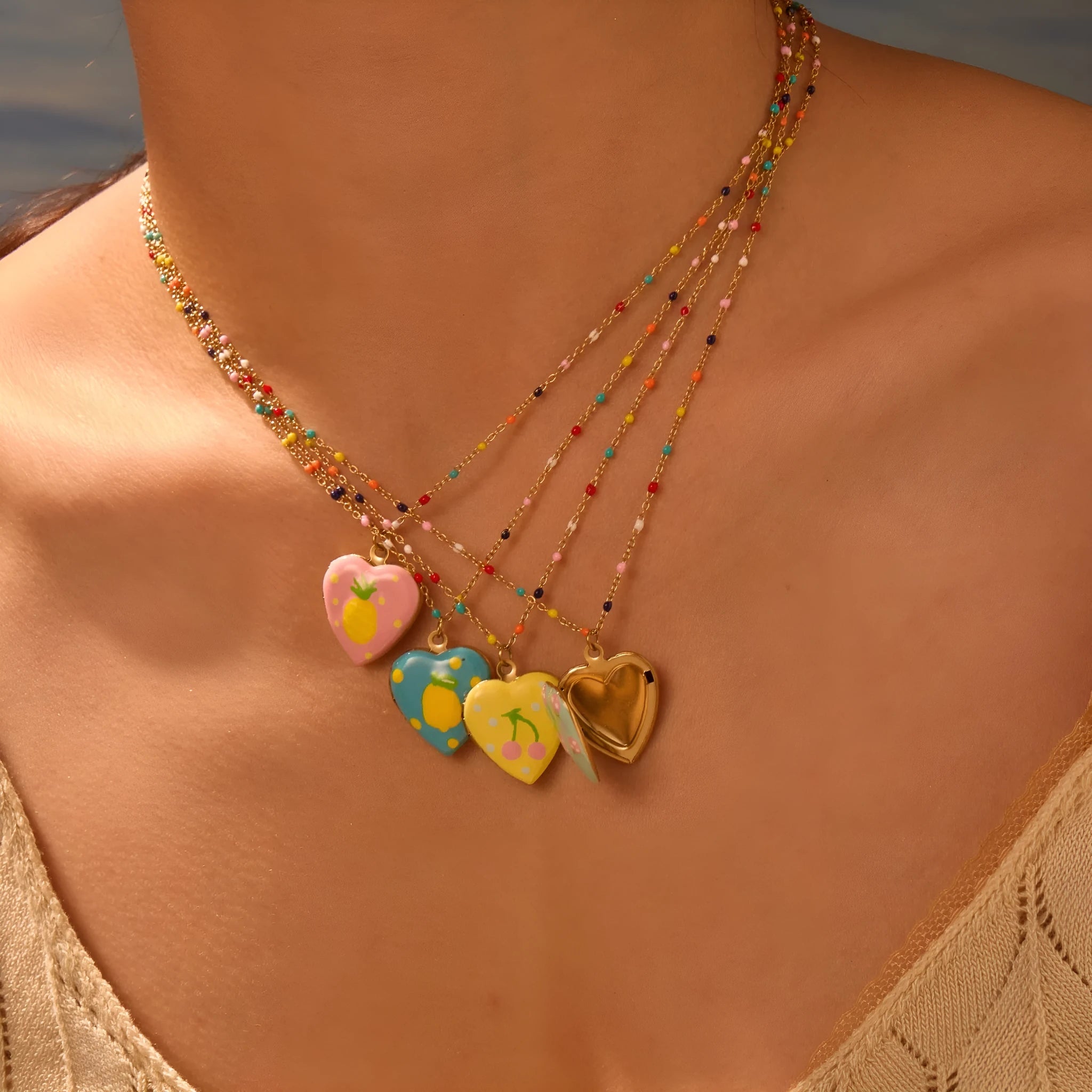 Gold-plated stainless steel necklace with heart-shaped fruit pendant on an adjustable chain.