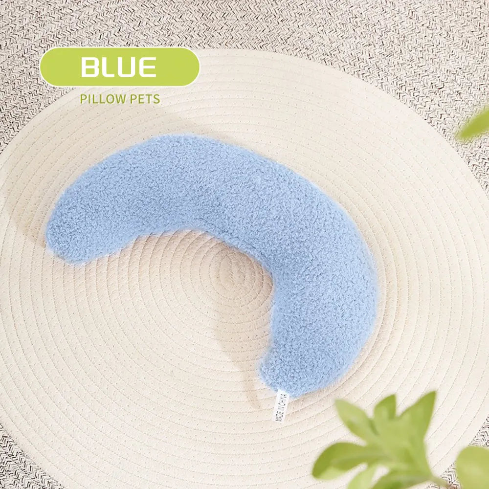 Blue U-shaped cat pillow with an integrated adjustable fabric collar on a grey blanket