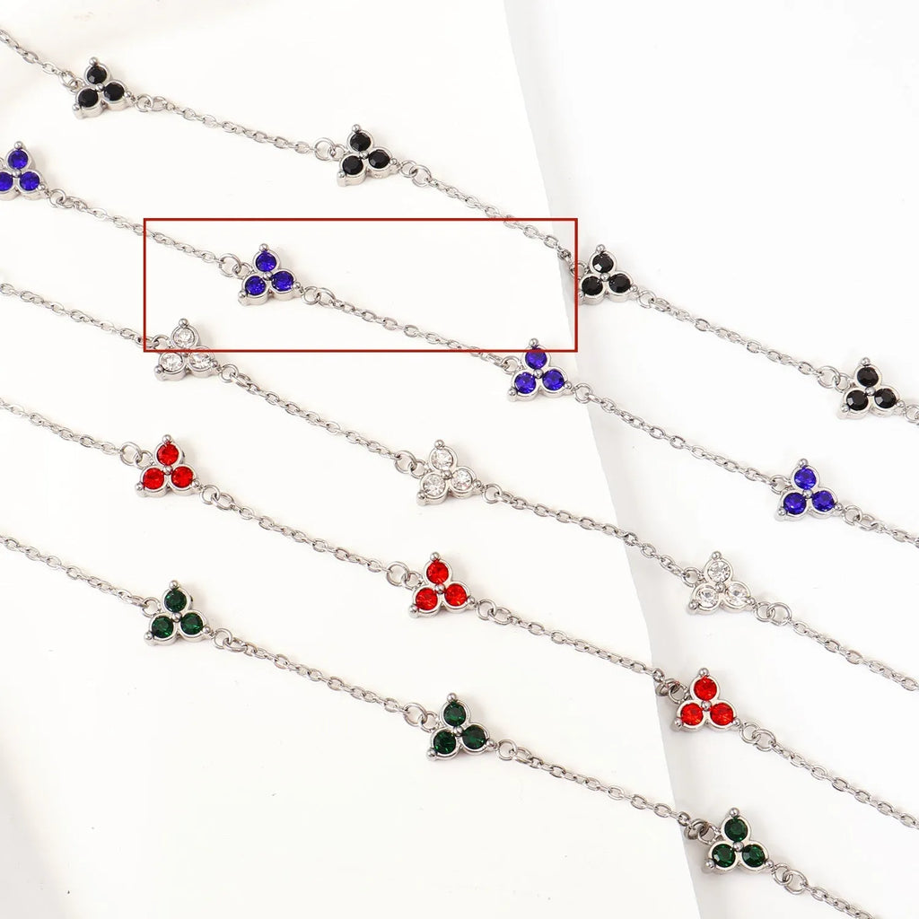Women's stainless steel geometric bracelet with triangle design and three-diamond centrepiece in gold or steel finish.