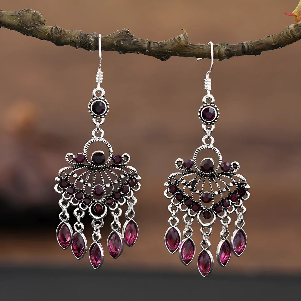 Purple drop-shaped earrings with long fringe detailing, showing retro ethnic style.